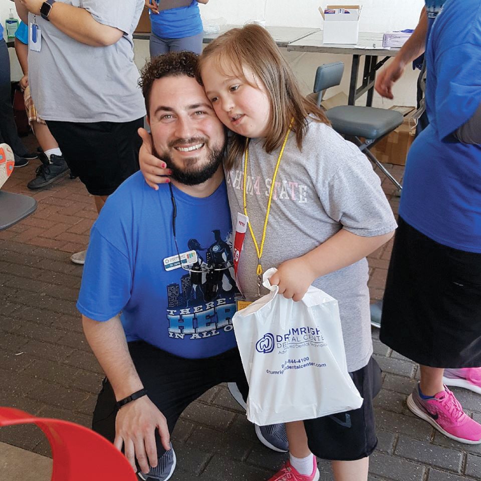 A Drumright Dental dentist poses for a photo with a Special Olympics athlete