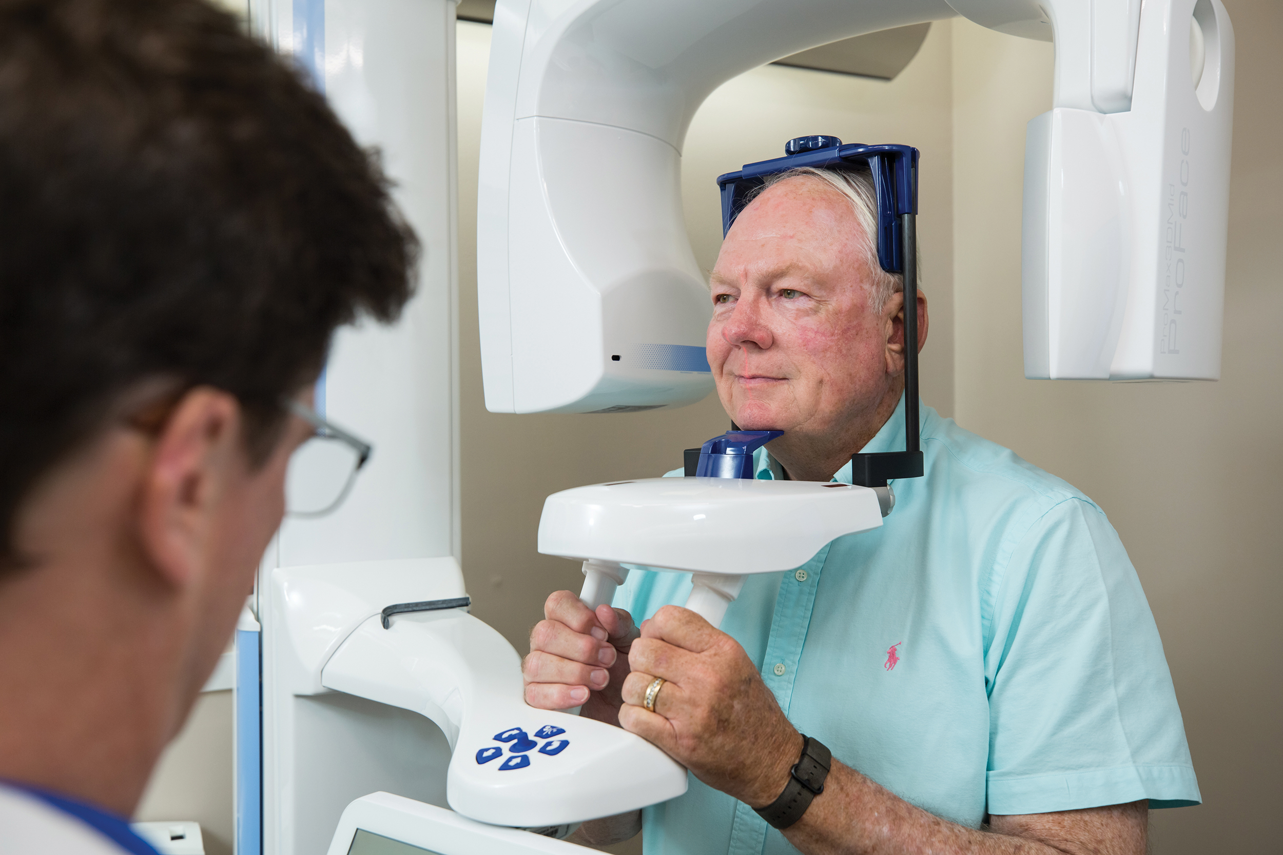 Dr. Alex Touchstone is showing how a Planmeca ProMax Mid CBCT unit works