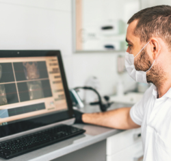 The Dentistry Divide – a dentist examines a digital x-ray