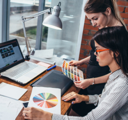 Two young women working on a new web design