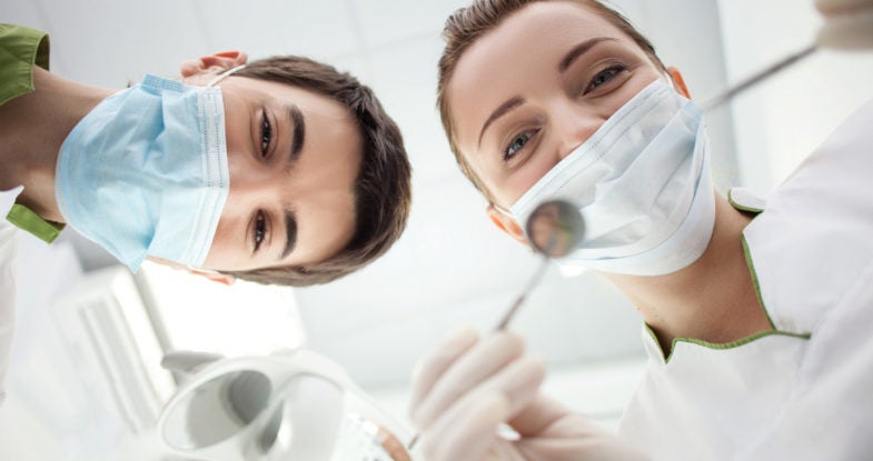 A doctor and dental hygienist on the cover of the 2018/2019 Reference Catalog