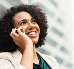 Woman on the phone giving a referral to a friend