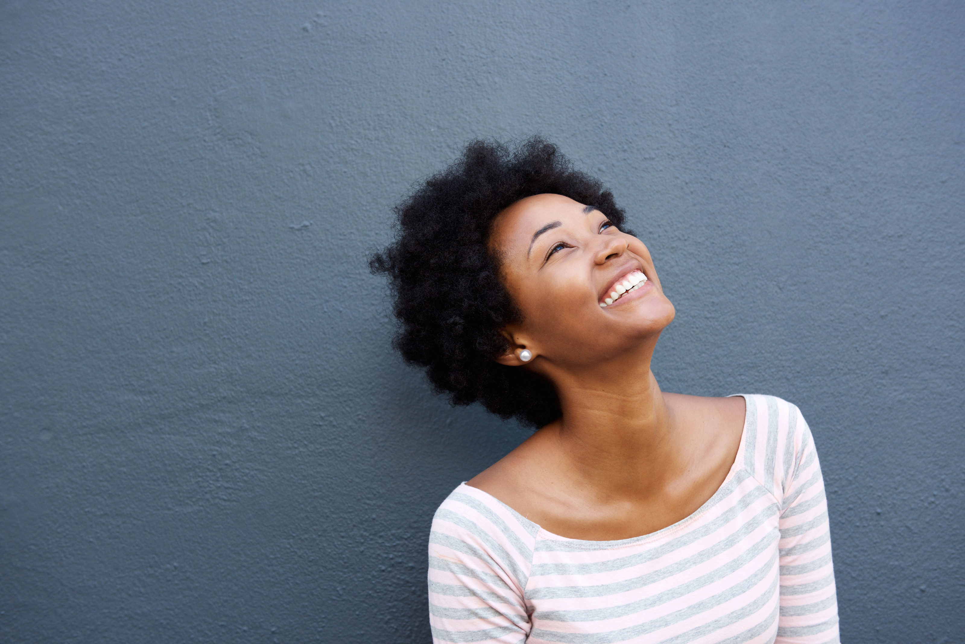 Happy woman looking up with a smile