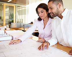 Two colleagues discussing office planning and design