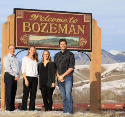 Dentists in front of Welcome to Bozeman sign