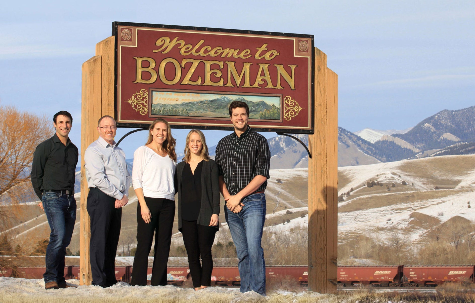 Dentists in front of Welcome to Bozeman sign