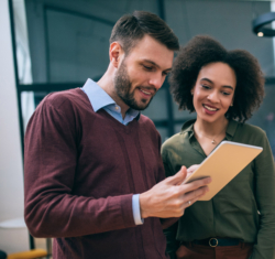 Two business people reviewing paper together