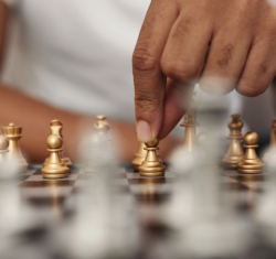 hand moving chess piece