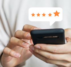 Your marketing strategy – like asking for reviews, referrals, and rejuvenating your social media are key to staying ahead of attrition and growing your dental practice. In the image we need two hands holding a cell phone in front of their body. Above the cell phone image we see five stars in a thought bubble-style call out.