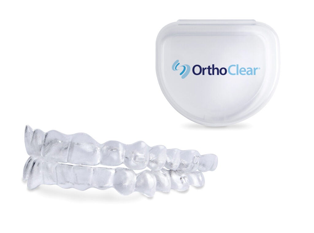 Introducing OrthoClear™ Aligners – the newest clear aligner treatment from DenMat and Burkhart Dental Supply. The image highlights an example of what the clear aligners look like that the case to store them. The deep blue and light blue OrthoClear® logo is on the case.