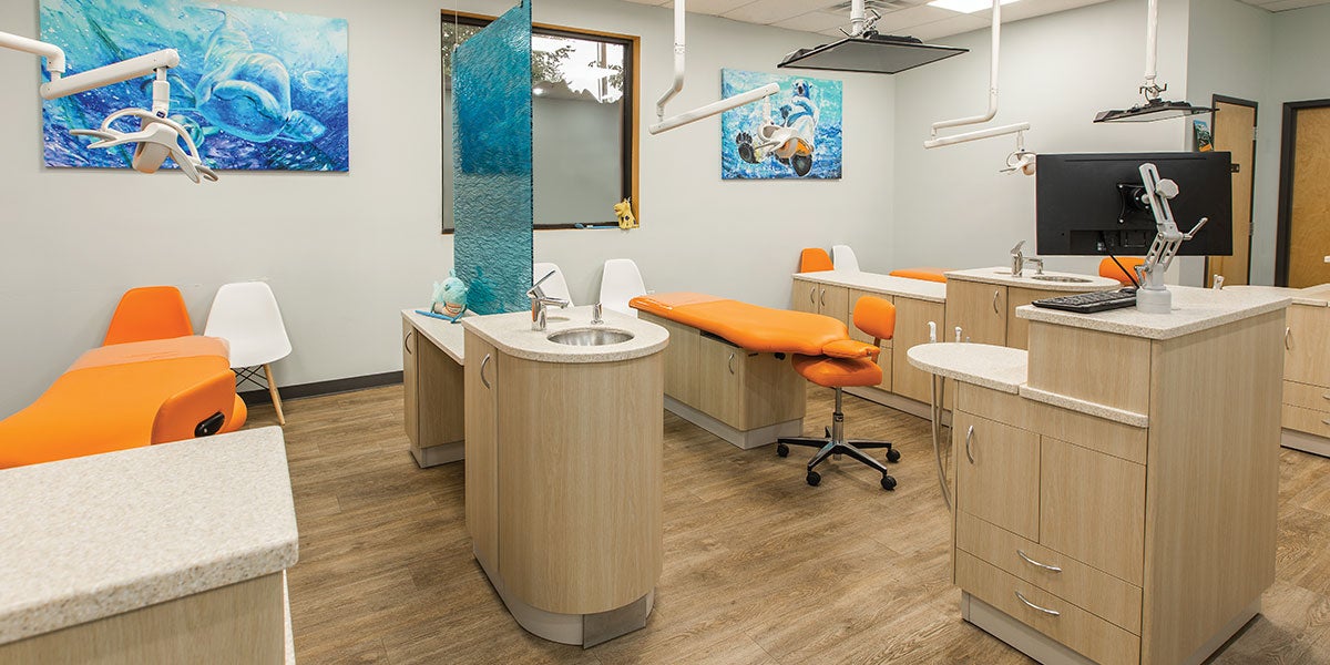 The warm wood colors paired with the pops of bright blue and orange on the hygiene and doctor chairs pull the welcoming environment throughout the space. The walls display art pieces of local wildlife painted by local artists.