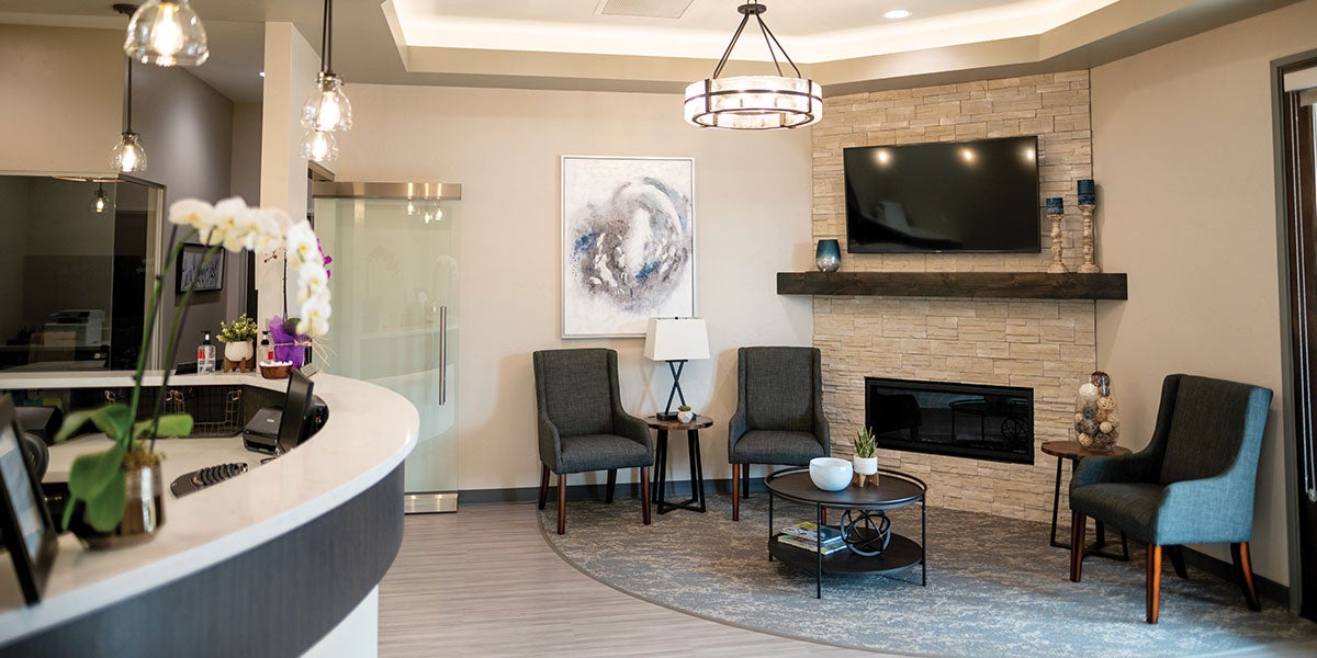 With a goal to make it feel less like a dental office and more welcoming, the lobby embraces elements of a living room. From the firelace to the big-screen TV, the rock wall and the countertops, are all chosen to feel more zen-like helping alleviate patient anxiety.